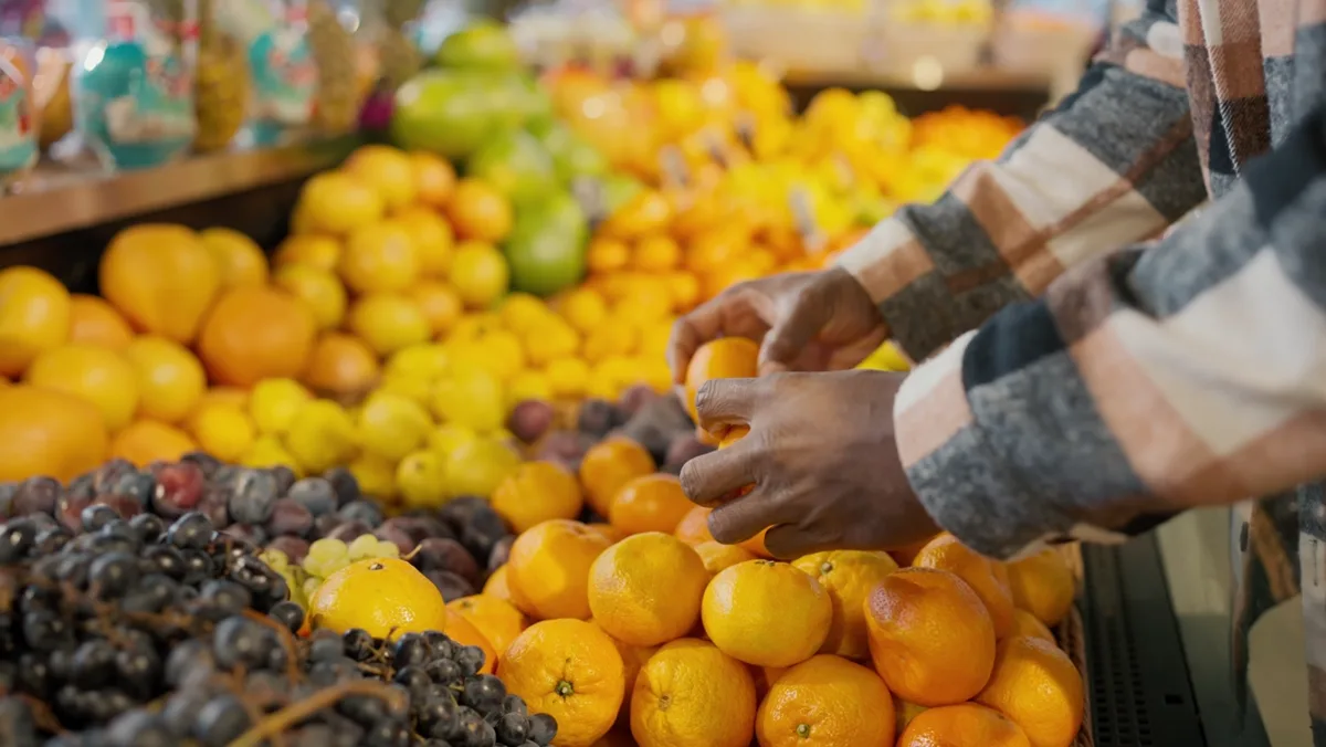 Fresh fruit being selected and handled at a produce market